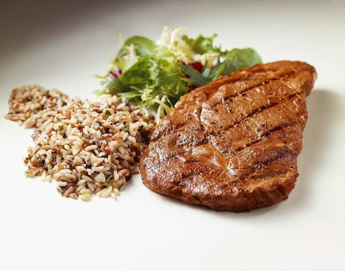 Grilled Steak with Wild Rice and Salad on White