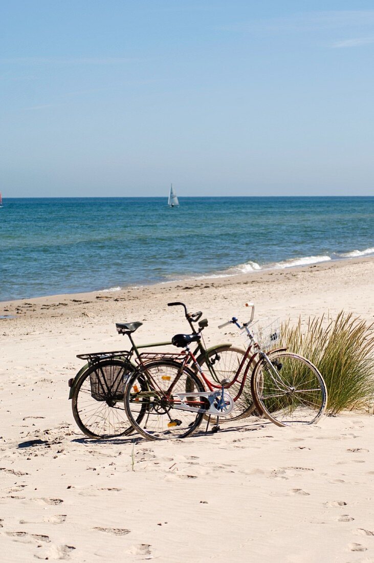 Two bicycles on a sandy beach