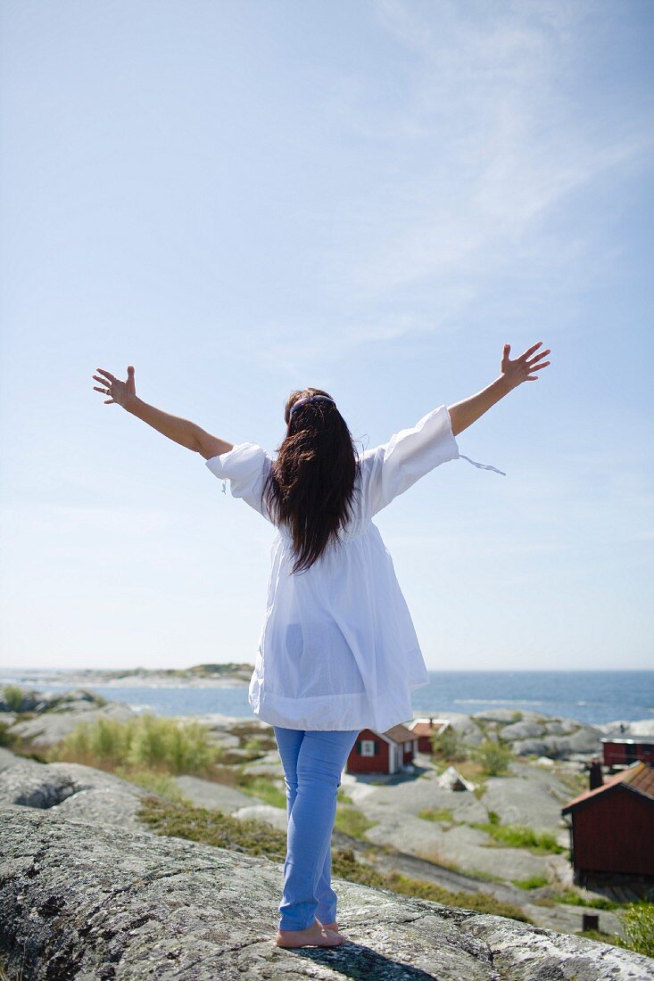 A woman on a rocky beach in Scandinavia