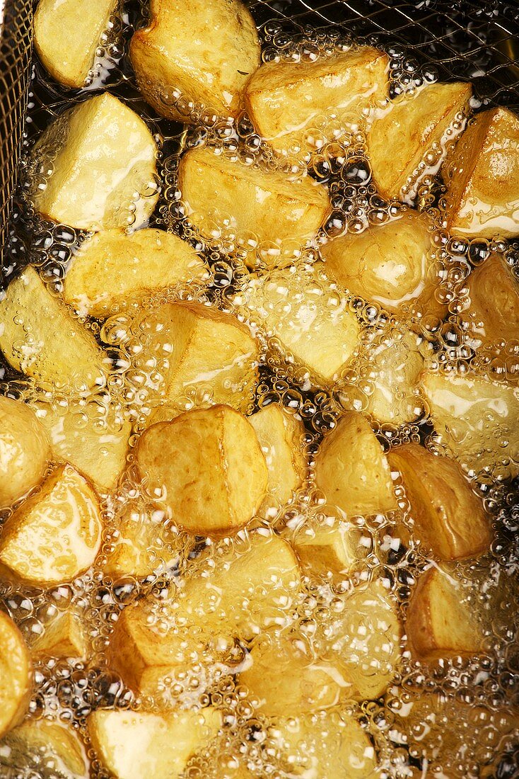 Potatoes being fried in hot oil