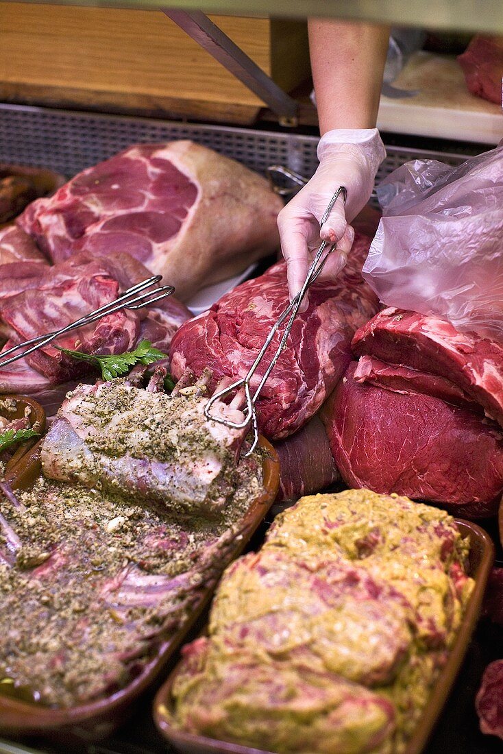 Fresh and marinated meat on display in a butchers