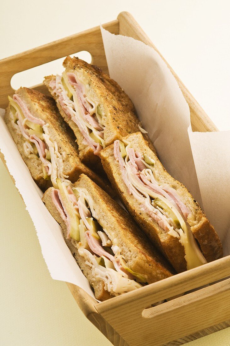 Ham sandwiches in a wooden box