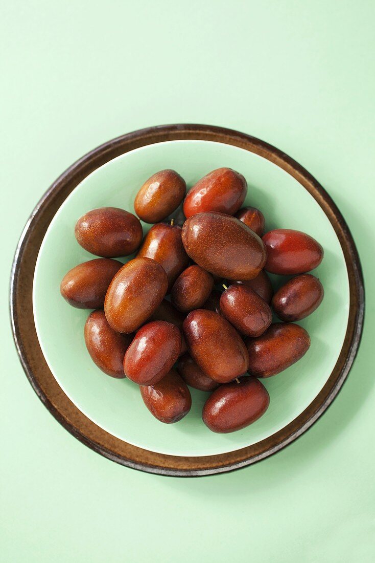 Jujube fruits in a bowl, seen from above