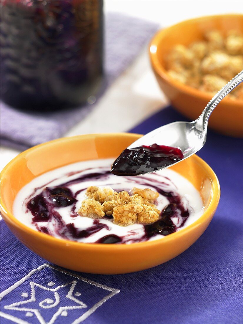 Yogurt with blueberry jam and cereals