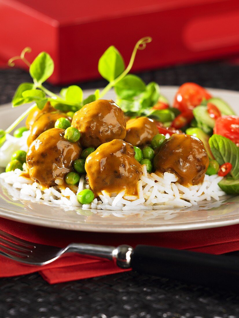 Meatballs with curry sauce on a bed of rice