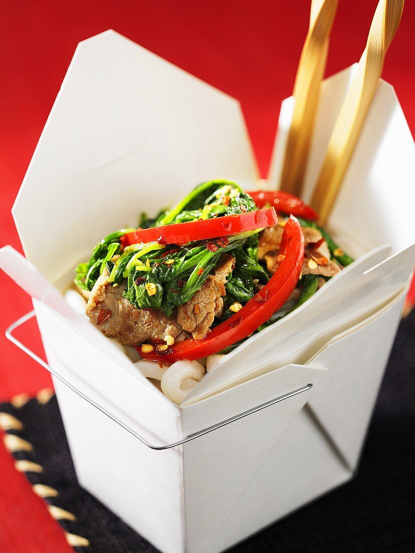 Pork with rocket in a take-away box