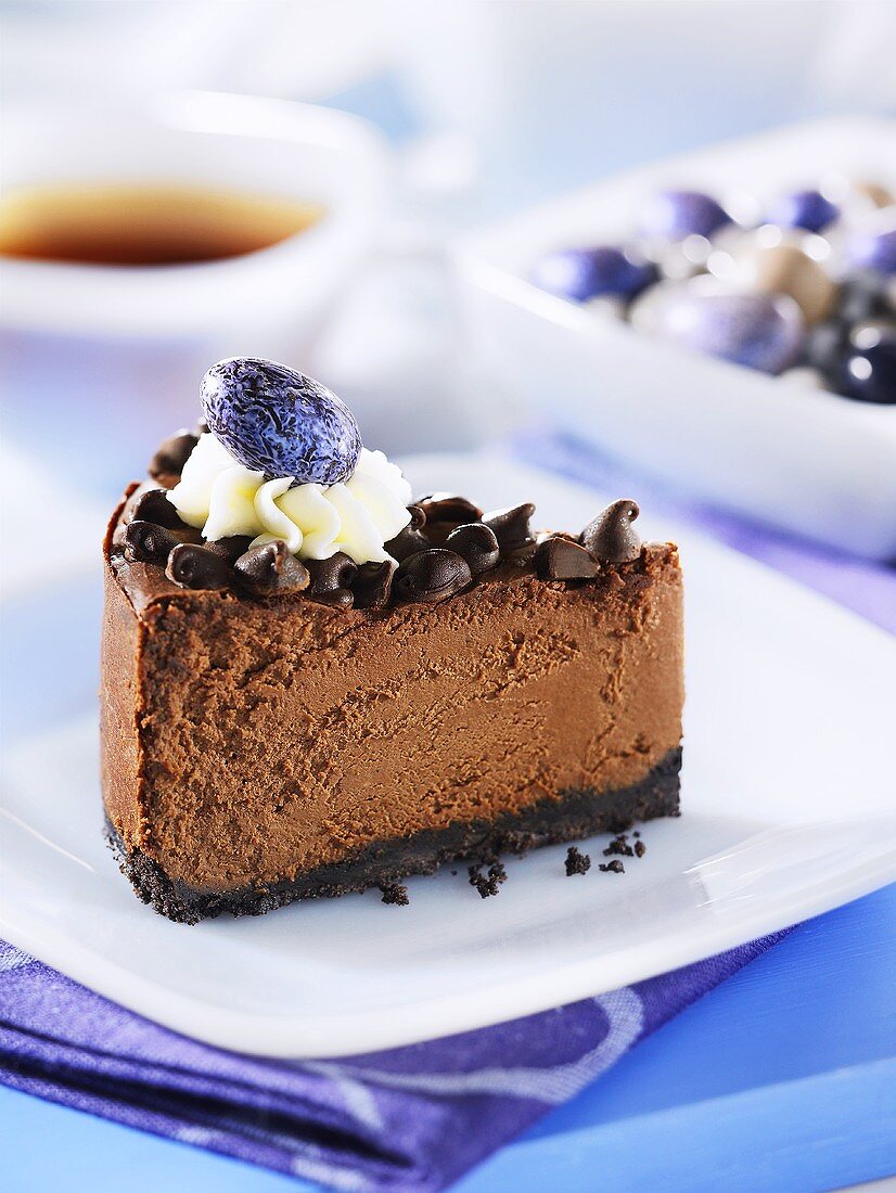A slice of chocolate cheesecake with chocolate chips