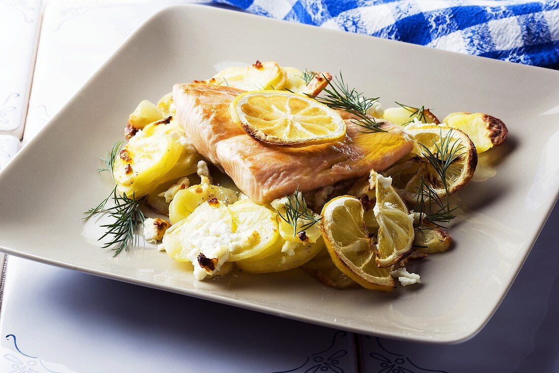 Salmon fillet with potatoes, lemons and feta cheese