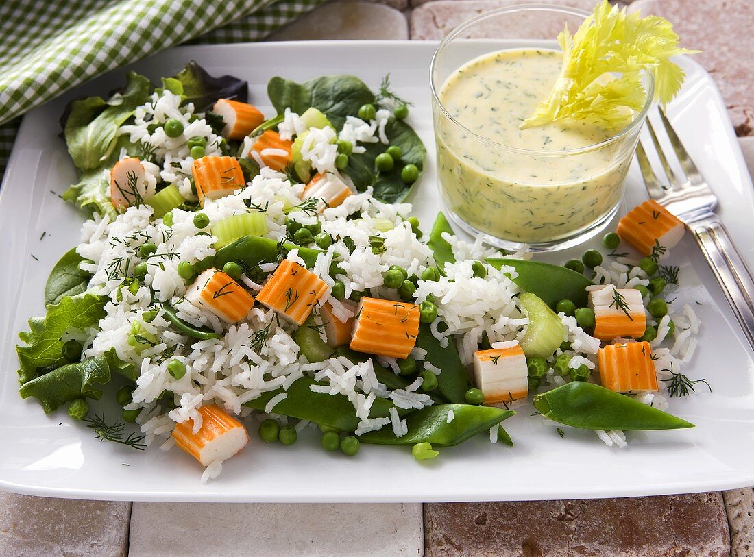 Rice salad with surimi, mange tout and a yogurt dip