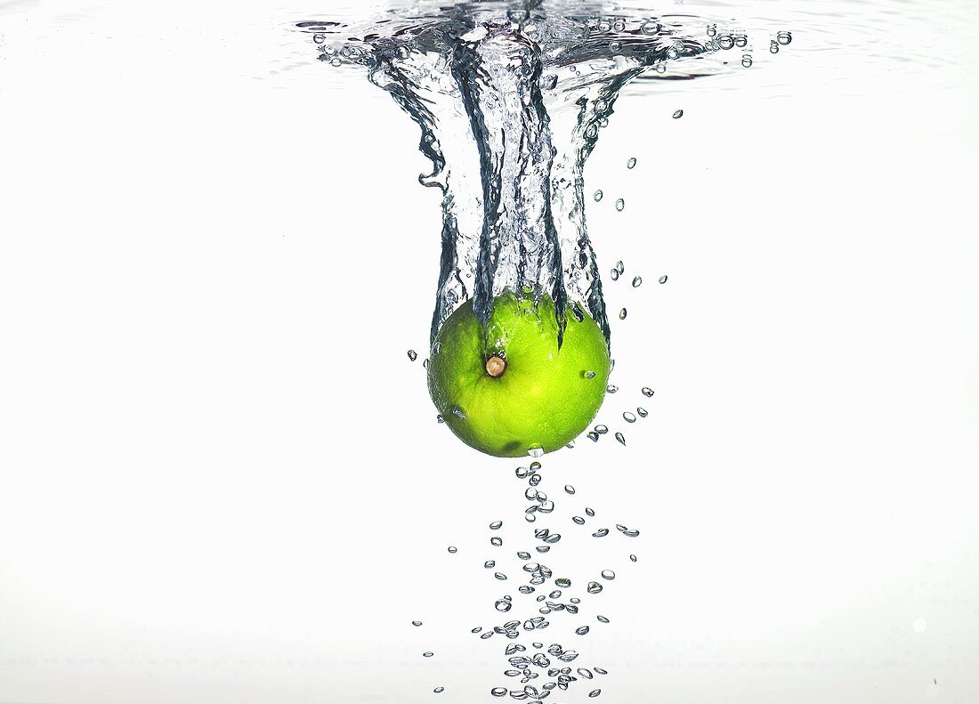A lime falling into water