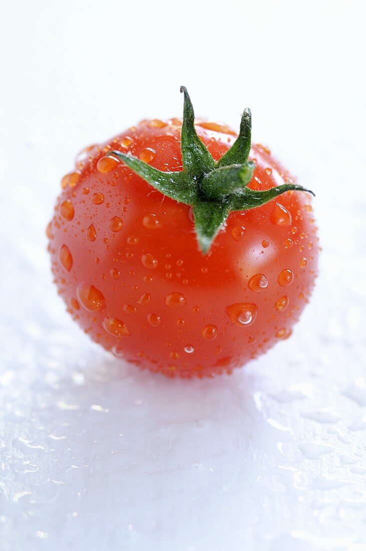 A freshly washed cherry tomato