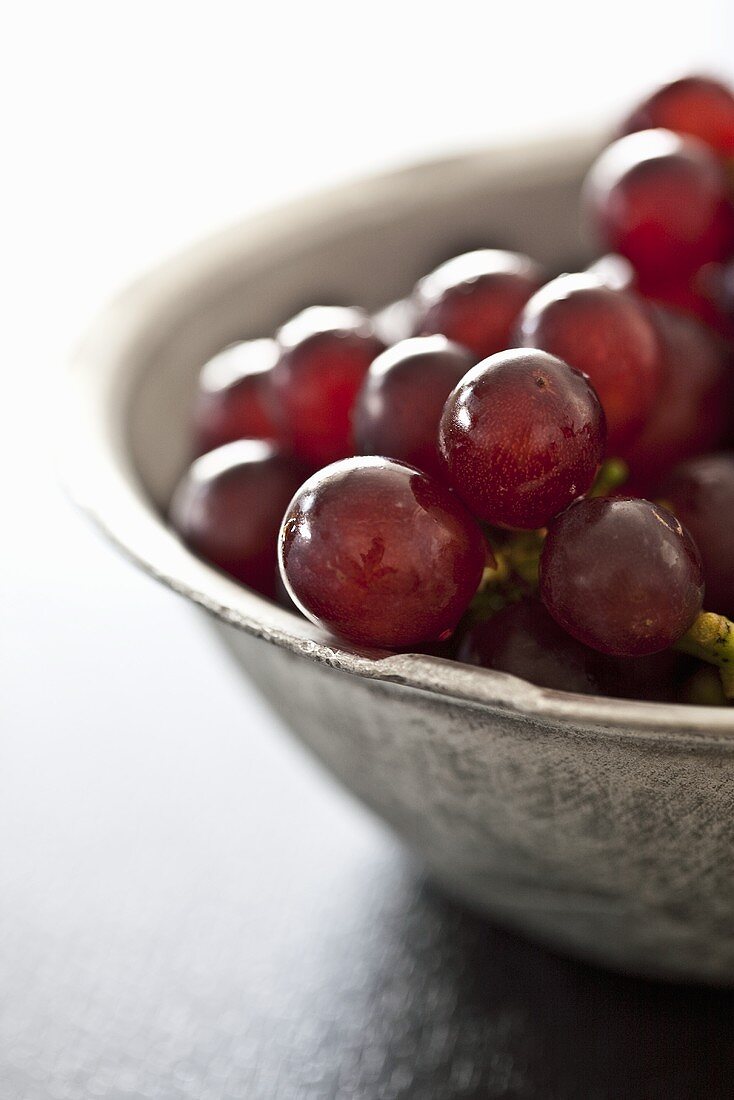 A bowl of red grapes