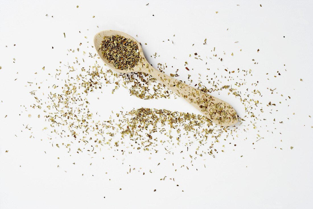 Dried oregano on a spoon and next to it