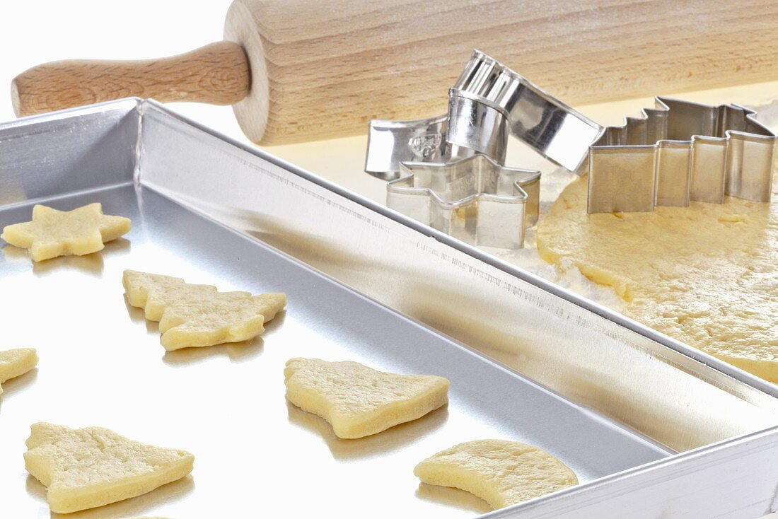 Cut out Christmas biscuits on a baking tray