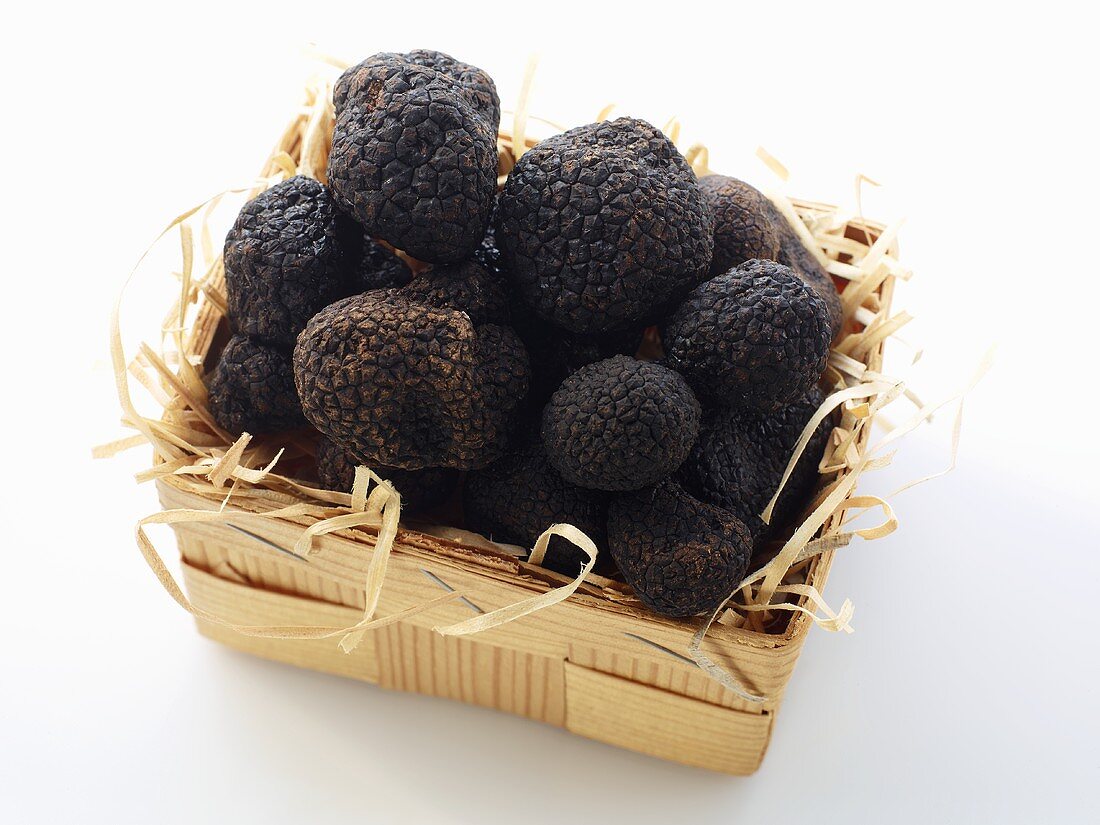 Black truffles in a wooden basket
