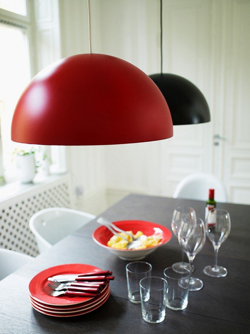 A dining room with lamps and a laid table