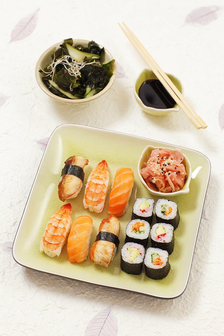 A plate of nigiri sushi and hosomaki sushi