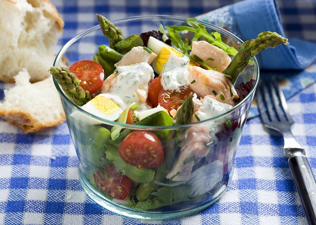 Salmon salad with green asparagus, egg and cherry tomatoes