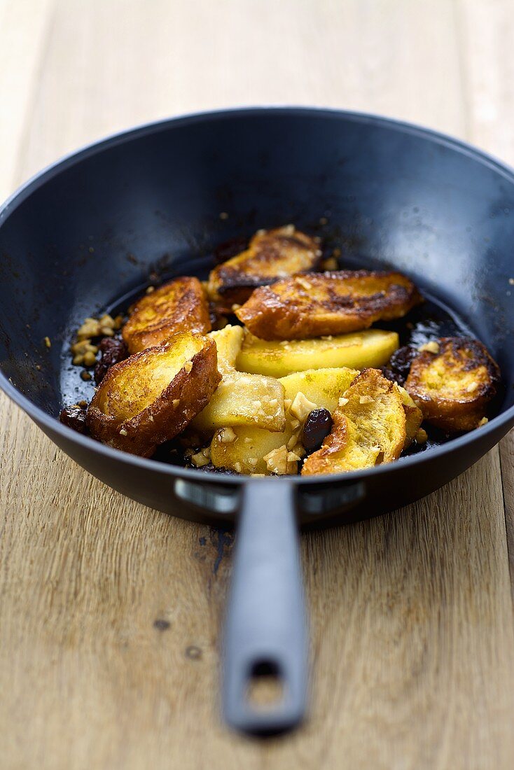 Shredded apple pancakes with raisins in a pan (Austrian dessert)