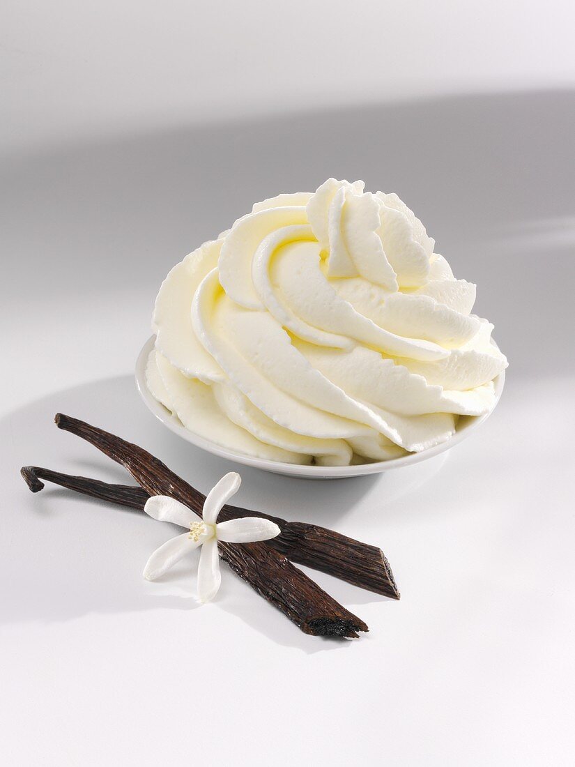 Vanilla cream, vanilla pods and a vanilla flower