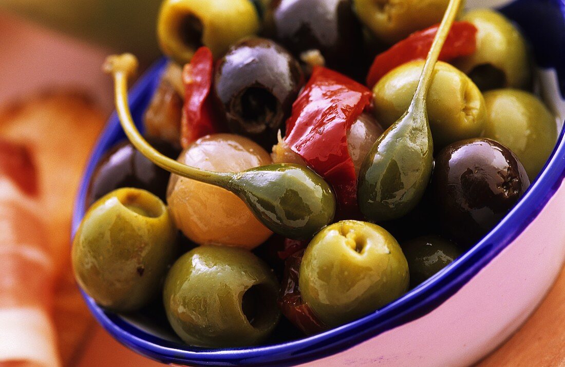 A bowl of marinated olives and capers