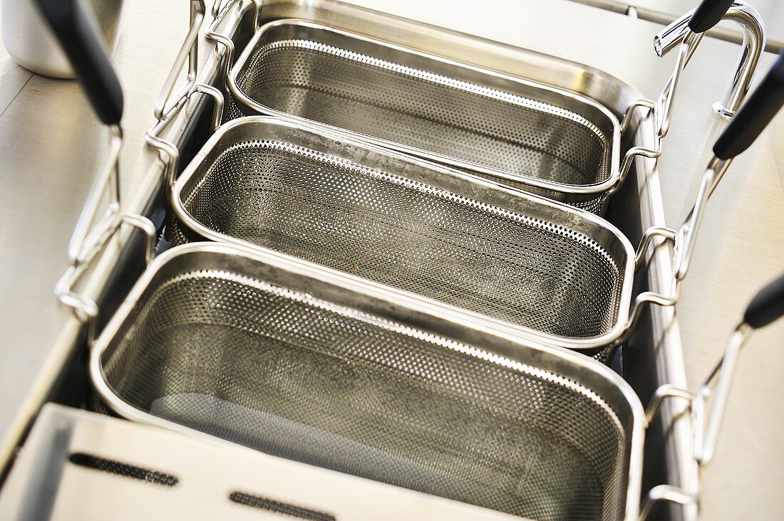 Deep fryers being cleaned with water