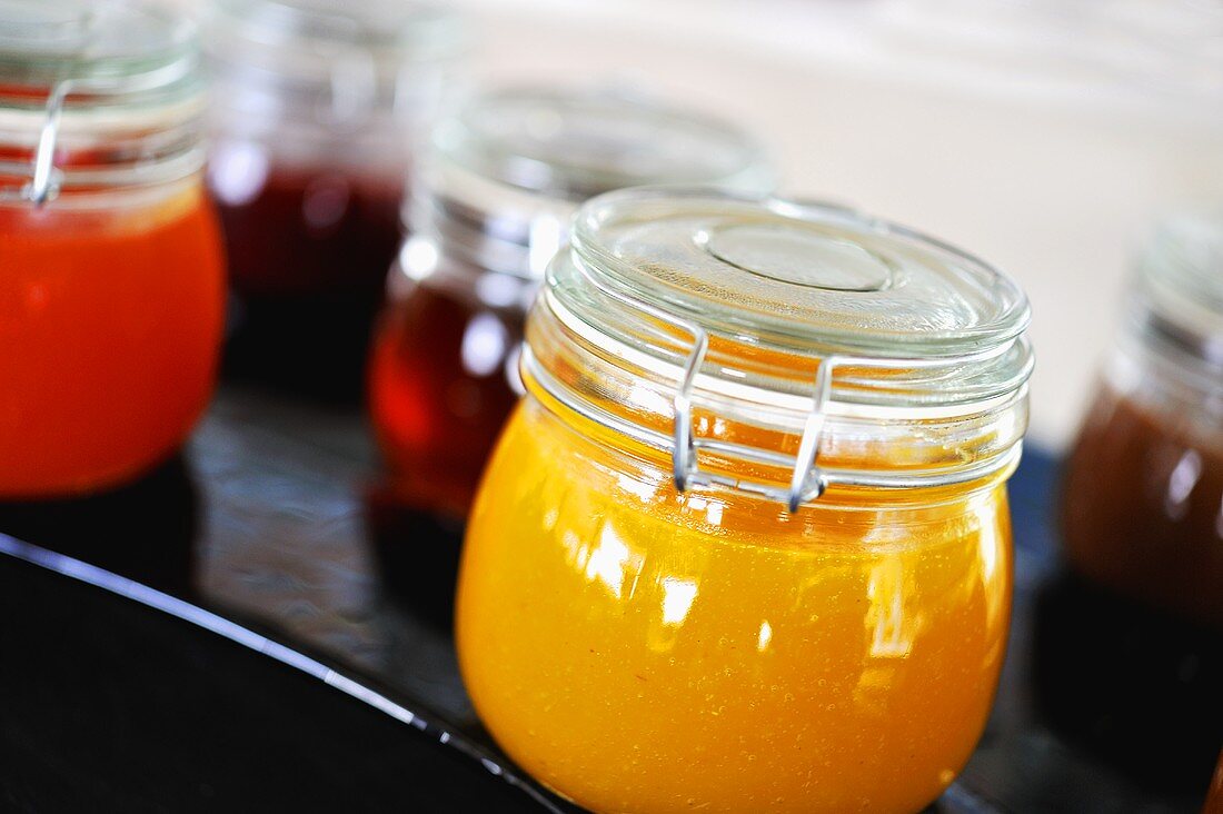 Different kinds of marmalade in jam jars