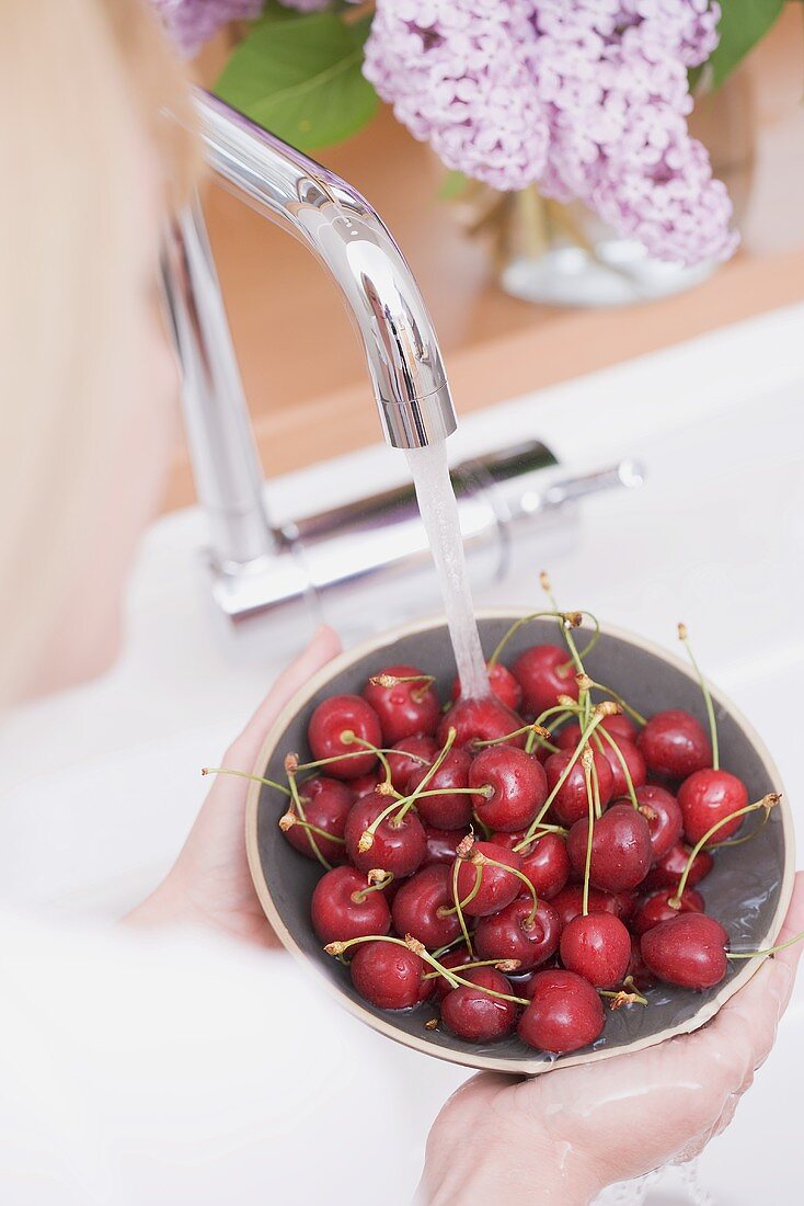 Cherries being washed in a bowl