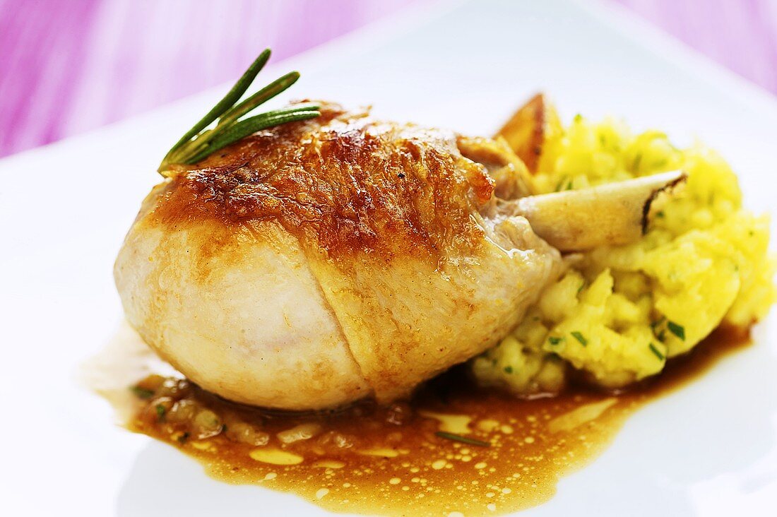 Leg of guinea fowl with mashed potatoes, lemons and olives
