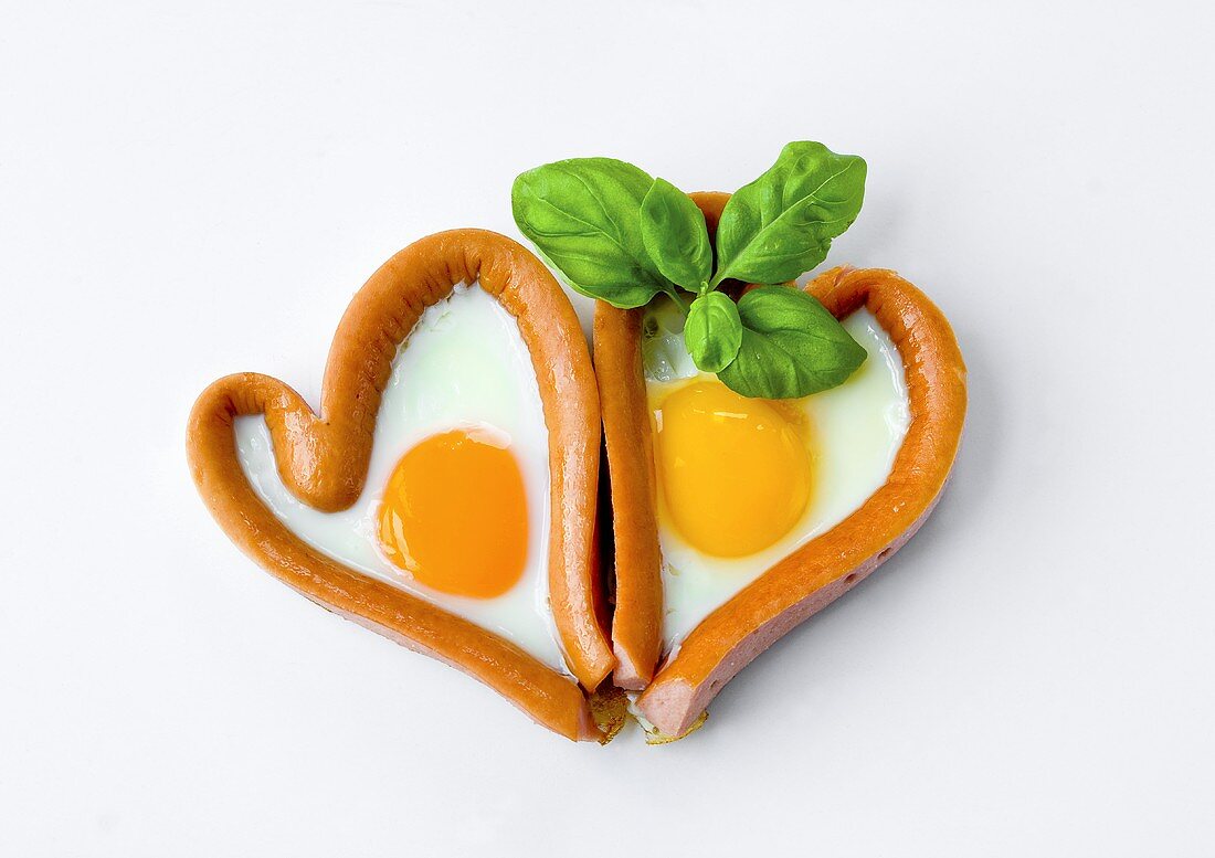 Two sausage and fried egg hearts