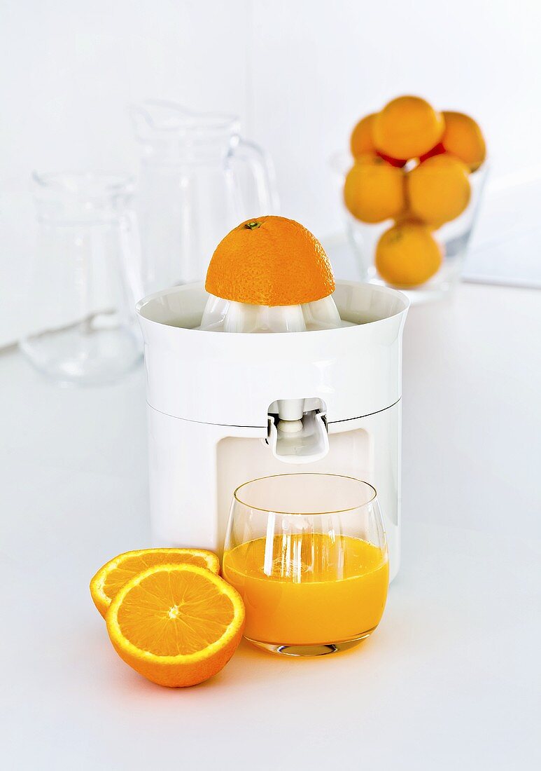 Freshly pressed orange juice with a juicer