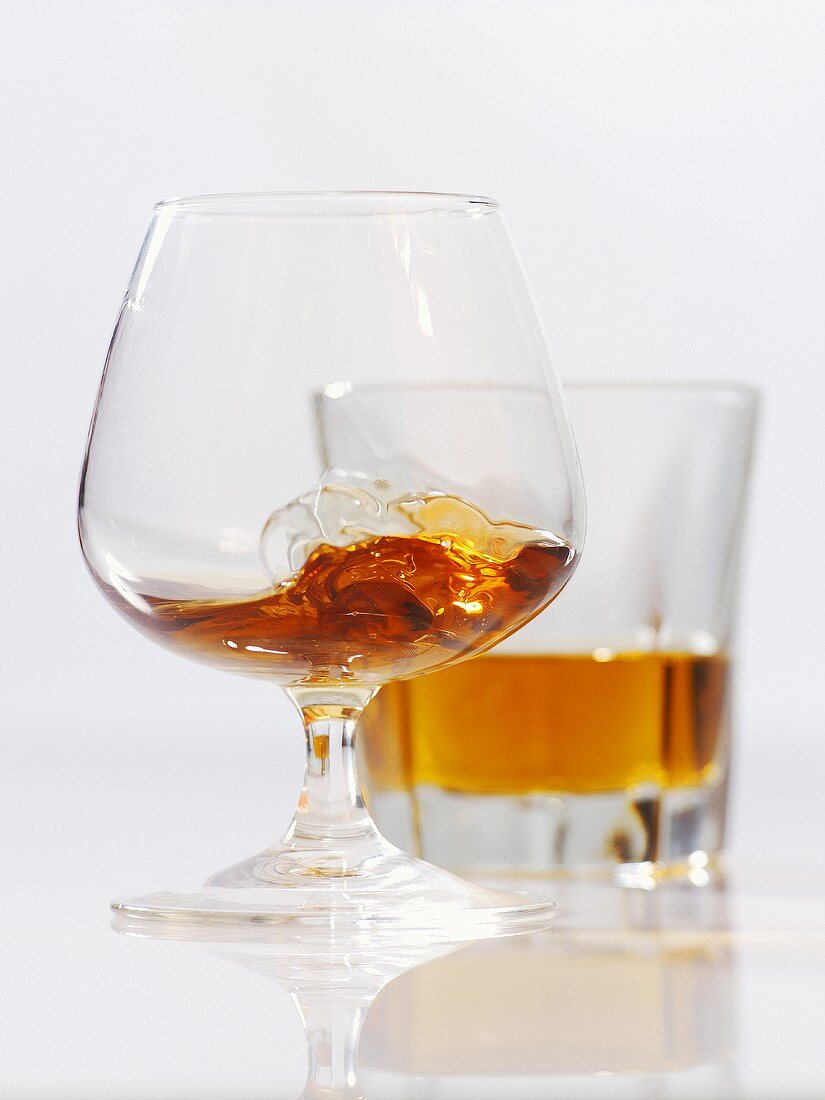 Cognac in a balloon glass and a glass of whiskey