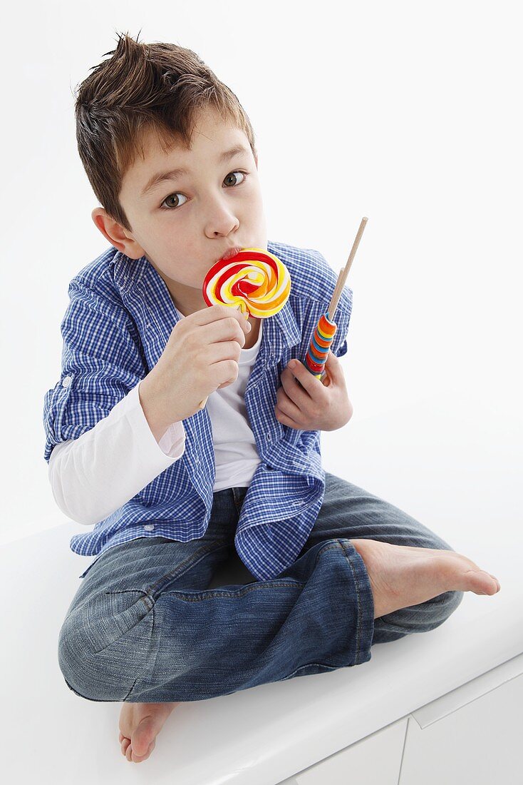 A little boy eating a lolly