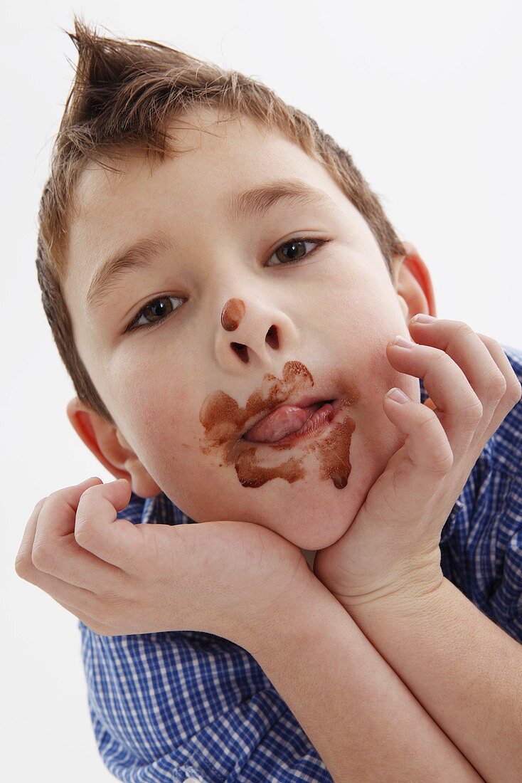A little boy with chocolate around his mouth