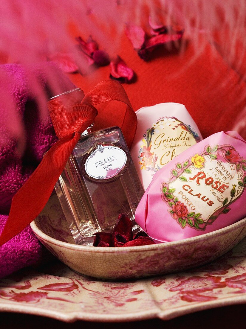 An arrangement of perfume, scented soaps and towels