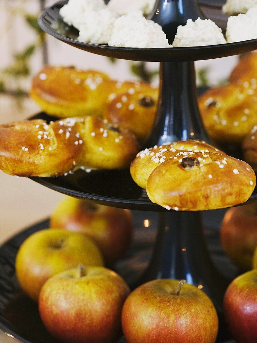Saffron pastries and apples on a cake stand
