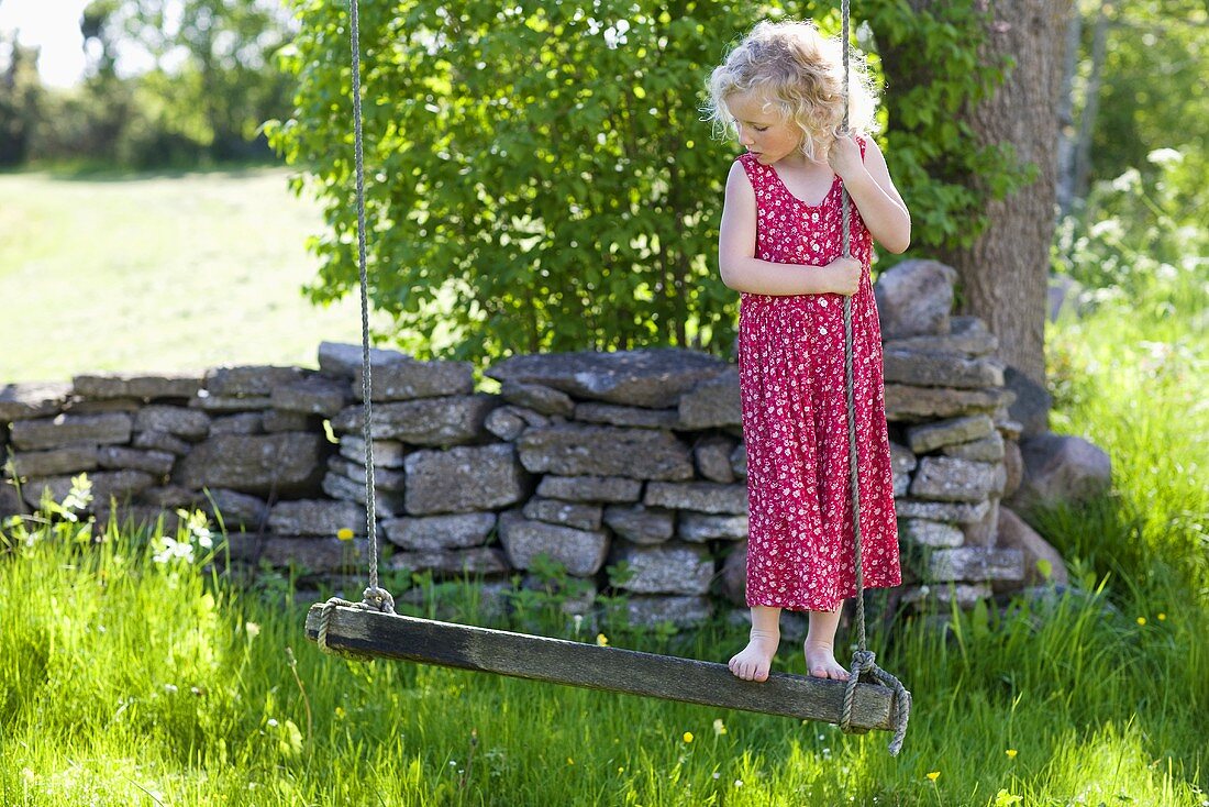 Little girl on a swing