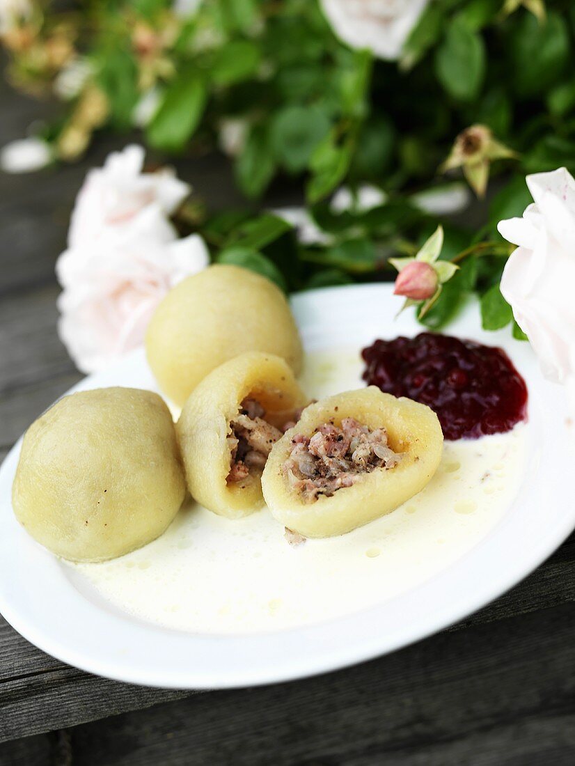 Filled potato dumplings with cranberry compote