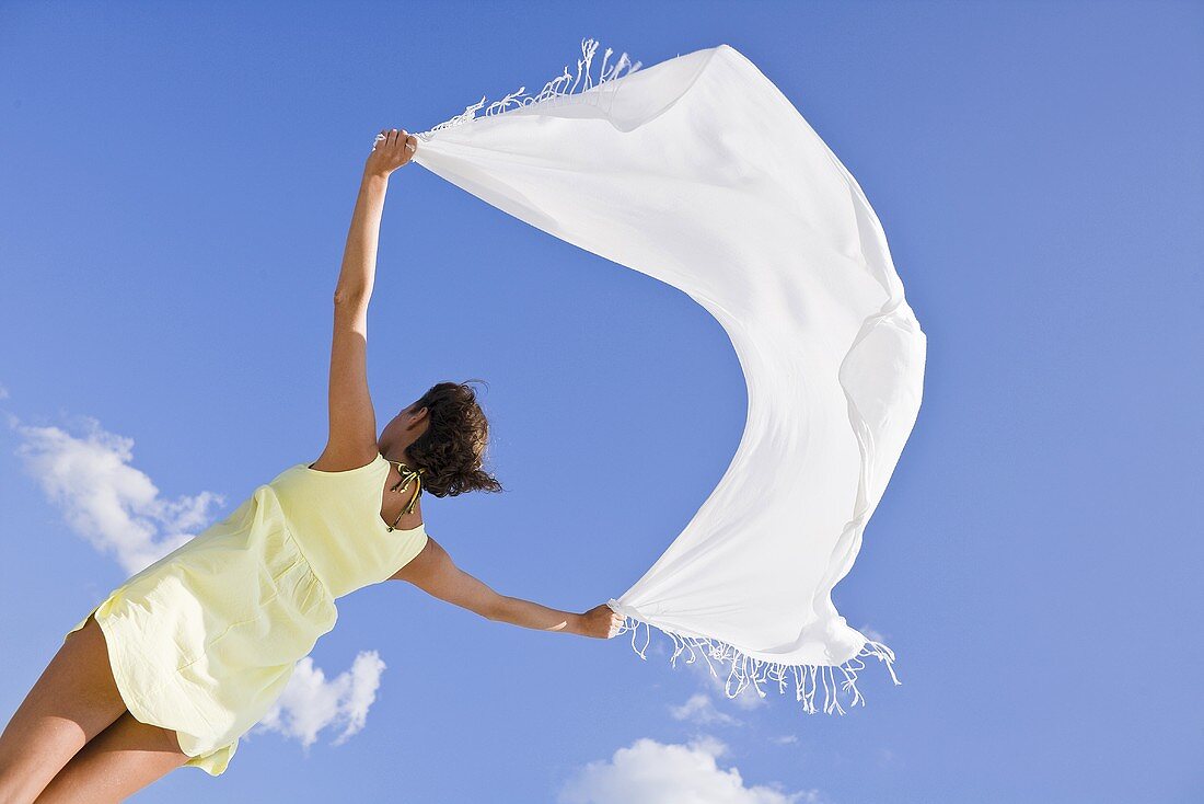 Women with a towel blowing in the wind