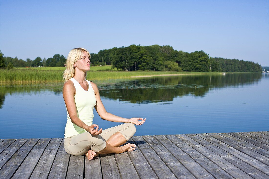 Blonde woman meditating in the Lotus position