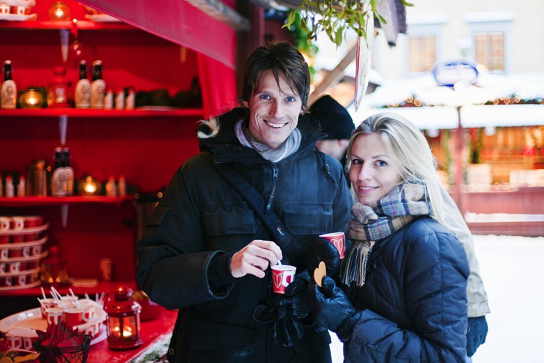 Couple drinking punch at a Christmas market