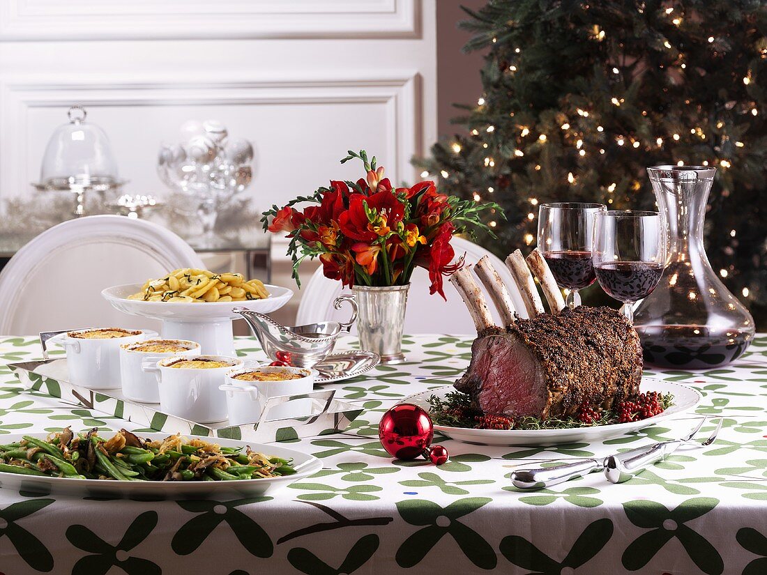 Christmas table with roast prime rib and side dishes