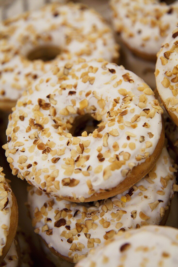 Iced donuts sprinkled with chopped hazel nuts