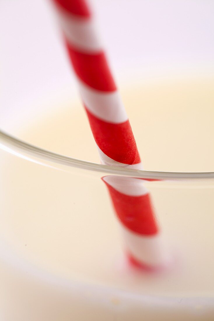 Glass of milk with a straw