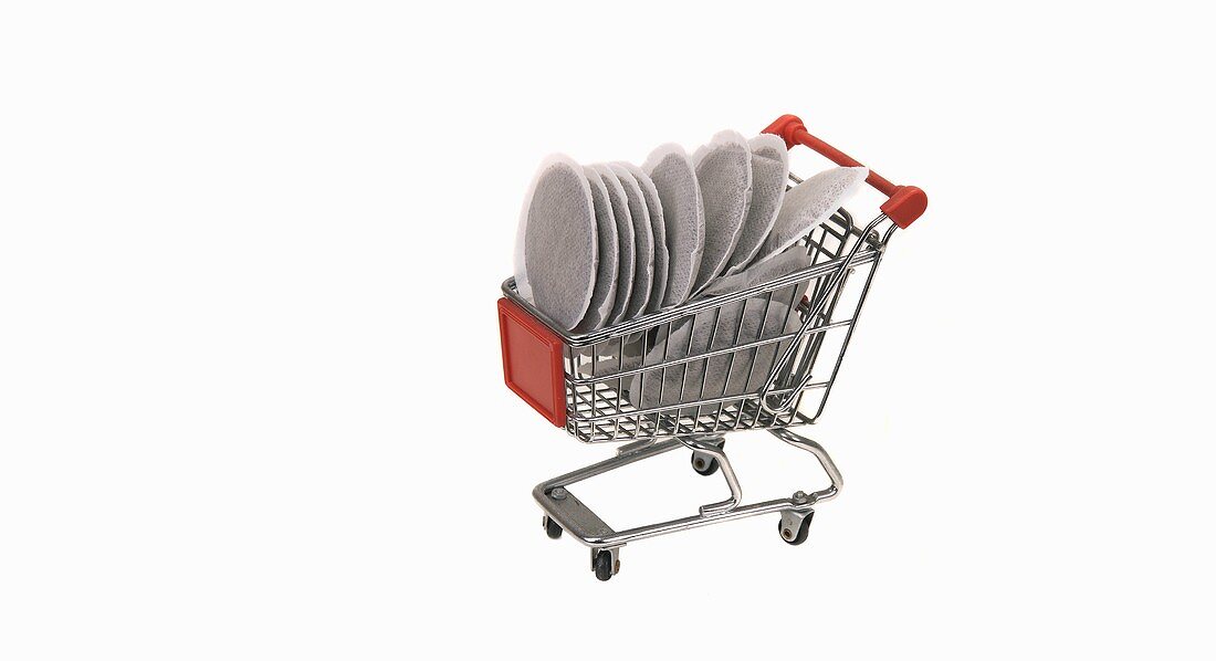 A model shopping trolley filled with coffee pads