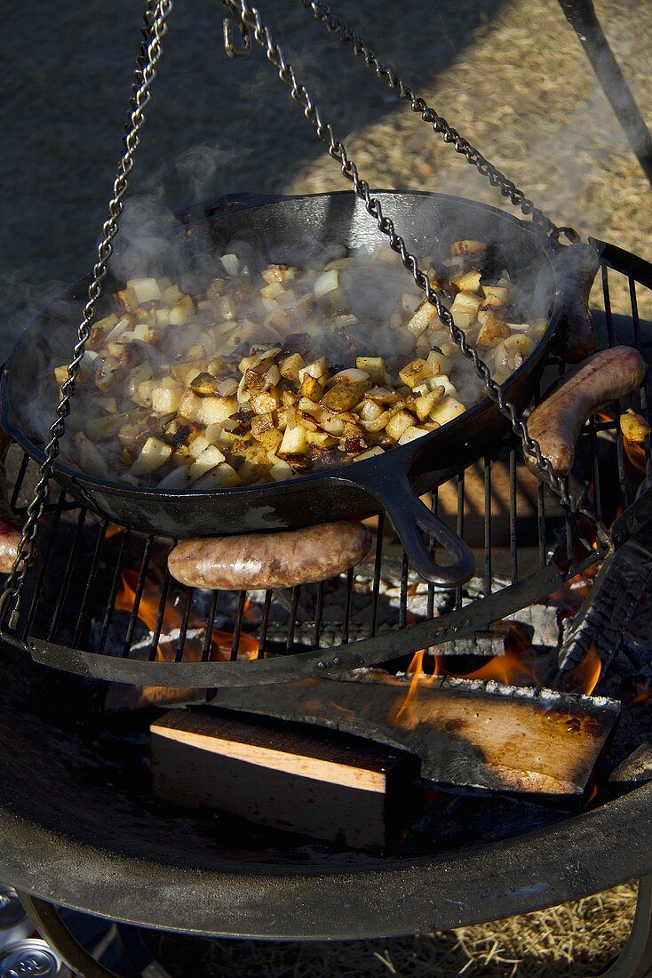 Kartoffeln und Bratwürste auf dem Campingfeuer