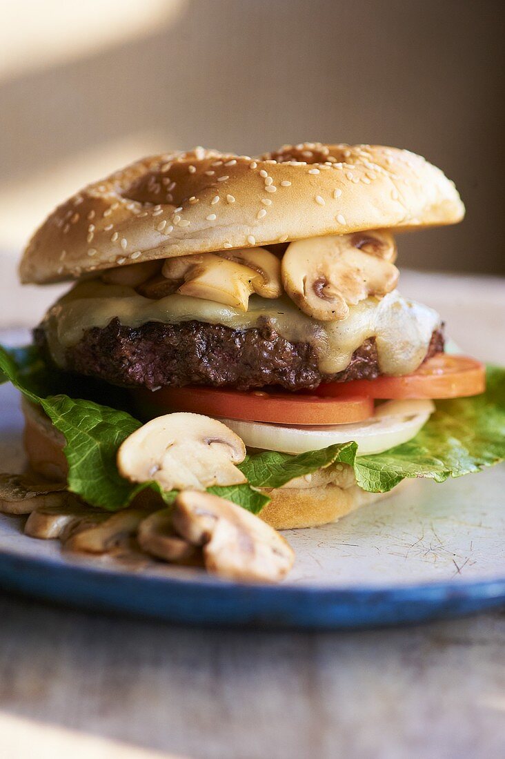 Cheeseburger mit Champignons, Tomaten, Zwiebeln und Salat