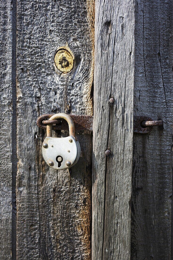 Padlock on an old wooden door
