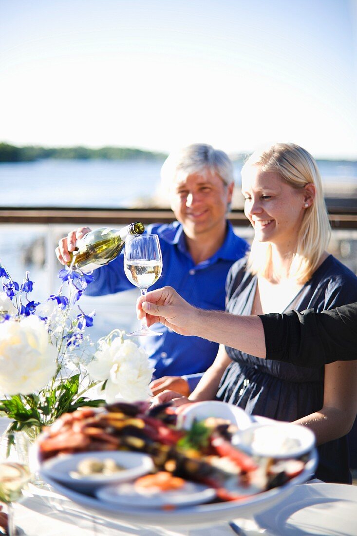 Leute beim Essen auf Restaurantterrasse