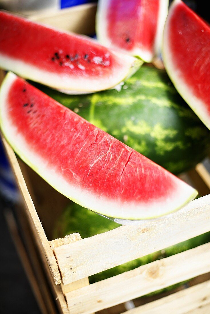 Watermelons, whole and sliced in a box